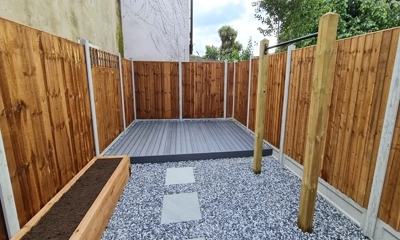 Sophisticated grey composite decking encircled by sleek black ice decorative stones.