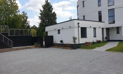 Penthouse driveway adorned with Drivesett 50mm Argent Block  Paving in evening glow. Chigwell area