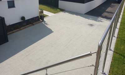 Elegant penthouse driveway with Drivesett 50mm Argent Block Paving in twilight.
