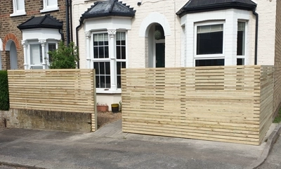Front garden fence crafted from treated sawn battens, rustic look in Walthamstow area 