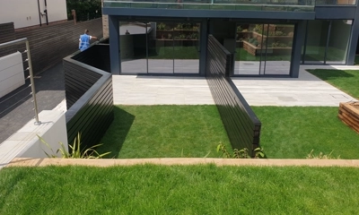 Sleek black Siberian larch fence adds sophistication to outdoor surroundings.