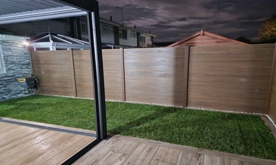 Sleek garden fence composed of durable warm tech composite battens.