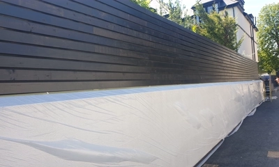 Elegant landscape: Black-painted Siberian larch fence exudes modern charm and sophistication.