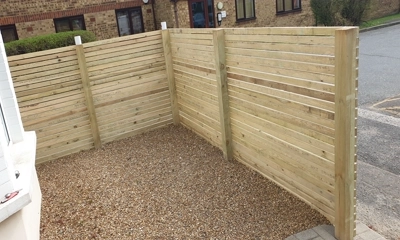 Sawn treated battens frame front garden, enhanced with pea shingle 