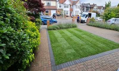 Residential driveway transformed with a seamlessly integrated, vibrant lush green lawn.