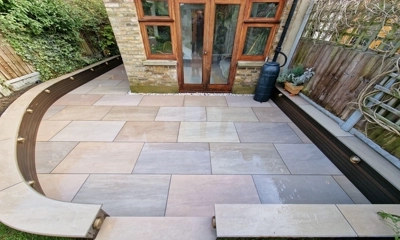 Elegant patio with Raj Green porcelain slabs, a timeless masterpiece in Woodford  landscaping project 