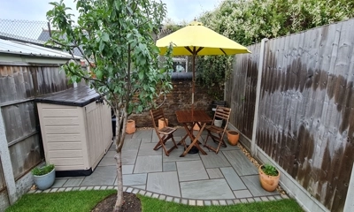 Inviting Italian ambience: Kandla gray patio, varied layout, beneath rustic tables.