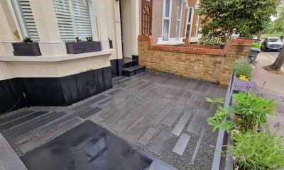 Front garden allure: random granite planks complemented by granite chipping elegance. est london landscaping 