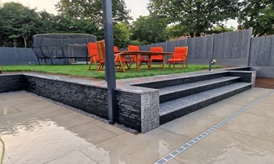 Retaining wall elevated with Imperial Black Slate Cladding, silver granite steps.