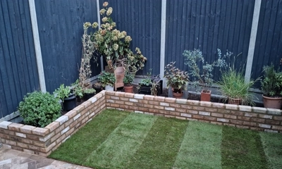 L-shaped planter wall crafted from Montreal Maple Paving Brick elegance.