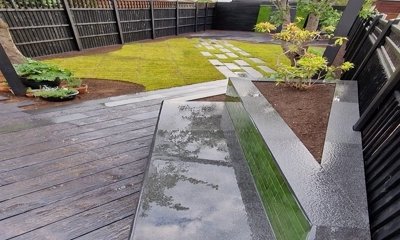 Modern planter: Granite planks border a chic glazed brick facade.