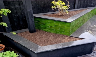 Granite plank planter with a sleek glazed brick exterior design.