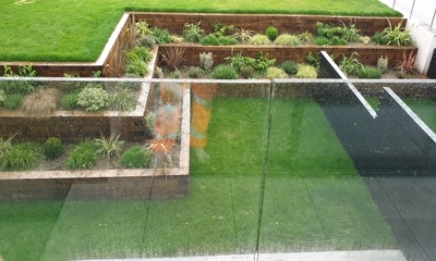 Three-tiered wooden planters filled with vibrant greenery and flowers.