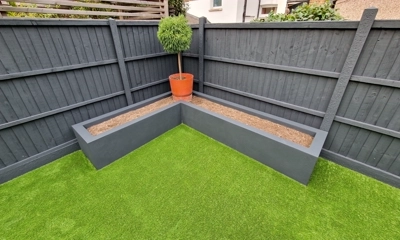 L-shaped Dark Blue rendered planter stands out beautifully in garden